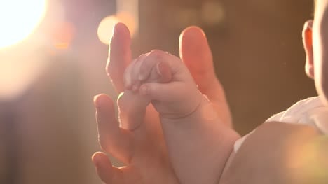 Mother-Holding-Babys-Hand-02