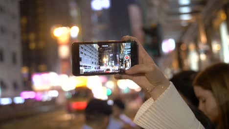 Person-Filming-Parade-on-Smartphone