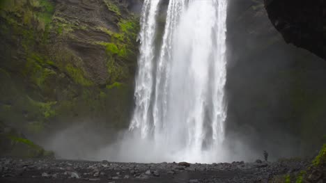 Man-At-the-Base-of-Large-Waterfall