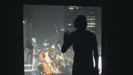 Silhouetted-Man-Looking-Out-of-Window